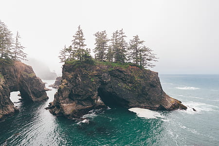 brown rock formation at the middle of sea thumbnail