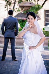 woman in white strapless wedding gown showing silence gesture thumbnail