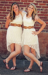 two women wearing white-and-beige crew-neck cap-sleeved dress thumbnail