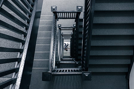 man lying on the floor near stairways thumbnail