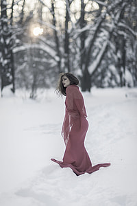 photo of woman in purple dress walking during winter thumbnail