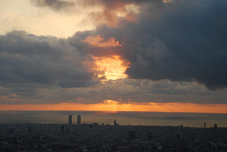 silhouette of buildings under gray sky thumbnail