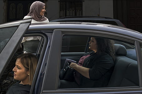 three women and one beside a vehicle thumbnail