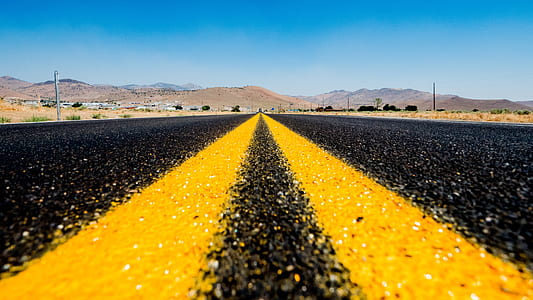 yellow parallel line on blacktop road thumbnail