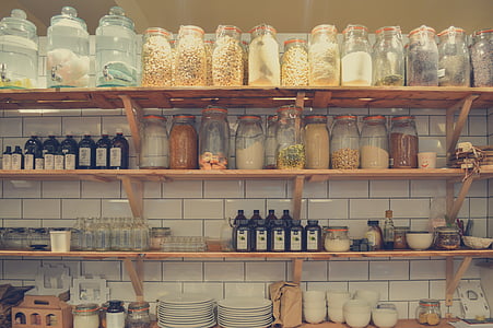 jars on rack above plates and bowls thumbnail