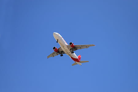 red and white airliner in the sky thumbnail