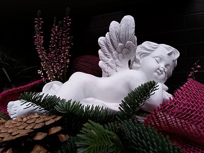 white cherub statuette beside pink mesh textile thumbnail