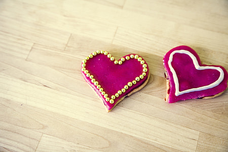 heart shaped cookies with pink cream and beads on top thumbnail