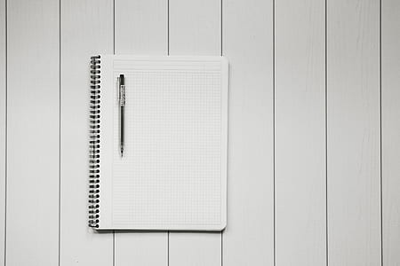 black click pen on white graphing spiral notebook thumbnail