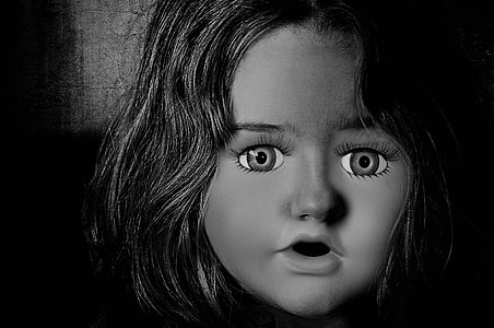 black haired doll figure close photography thumbnail