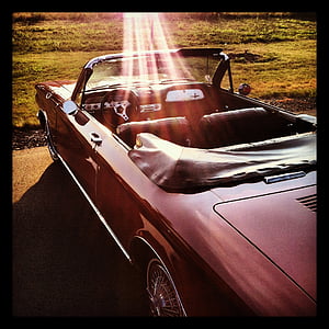 red convertible coupe parked on green grass during daytime thumbnail