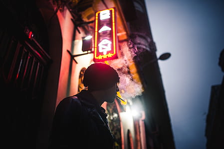 man wearing black knit hat standing concrete building thumbnail