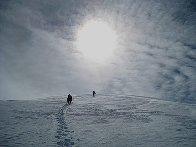 two person walking under white clouds thumbnail