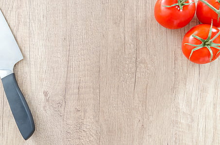 three tomatoes and stainless steel knife thumbnail