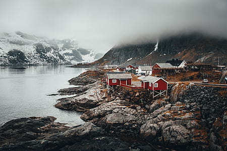 houses near body of water and mountain thumbnail
