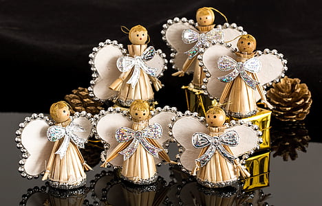 six angel baubles near pinecone on black table thumbnail