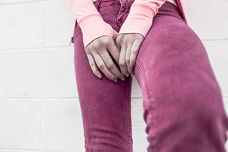 selective focus photography of woman holding her lap thumbnail