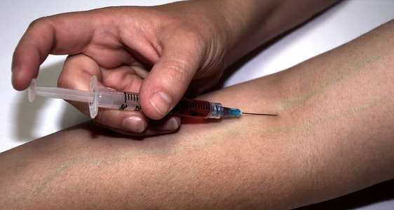 person injecting himself with a syringe thumbnail