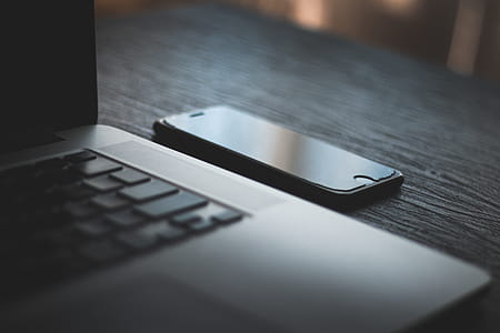 Iphone Beside Laptop Computer thumbnail