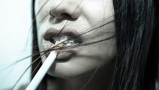 woman biting cigarette stick thumbnail