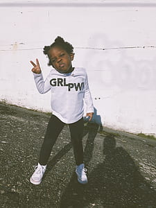 girl wearing white long-sleeved shirt and black pants thumbnail