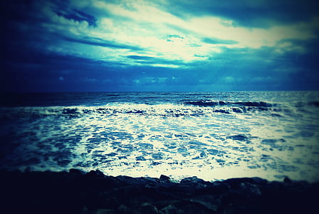 waves crashing on rocky shore during daytime thumbnail