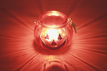 clear glass pumpkin bottle on red surface thumbnail