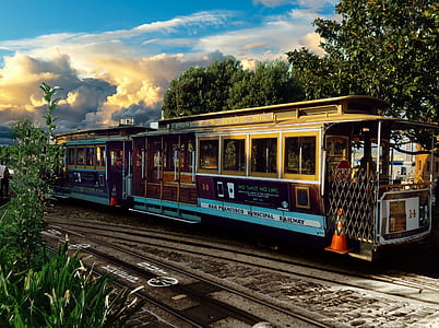 train between trees at daytime thumbnail