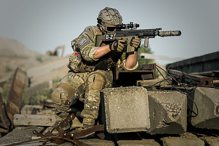 army holding gun during daytime thumbnail