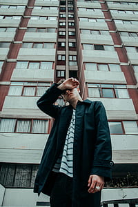 man standing near building thumbnail