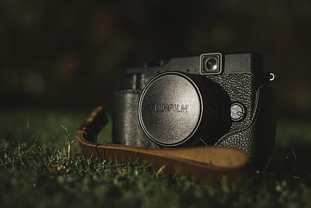 black DSLR camera on grass field thumbnail