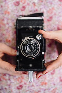 Woman in pink holding miscellaneous items thumbnail