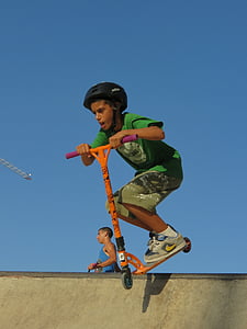 boy riding kick scooter thumbnail