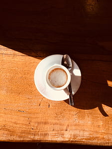 white ceramic teacup with brown and white foamy liquid thumbnail