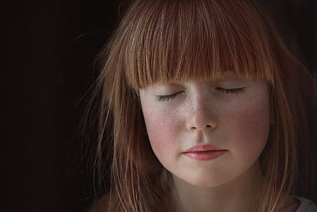 brown haired girl with eyes closed thumbnail
