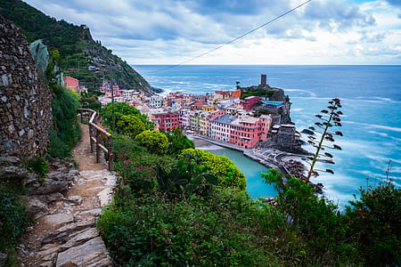 assorted-color buildings near sea shore thumbnail