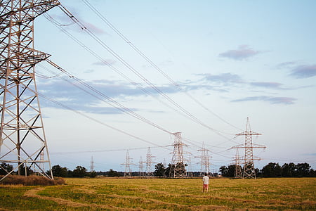 man standing near transmission towers thumbnail