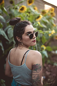 Woman Standing Beside Yellow Sunflowers thumbnail