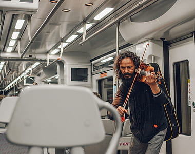 Man Playing Violin Inside Train thumbnail