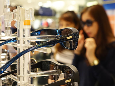 black sunglasses on rack near two women thumbnail
