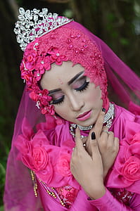 Woman In Pink Traditional Dress Wearing A Tiara thumbnail