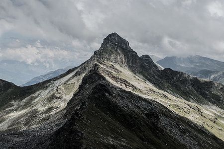 black and white mountain under gray cloudy sky thumbnail