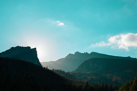 mountain covered with green leaf trees at day thumbnail