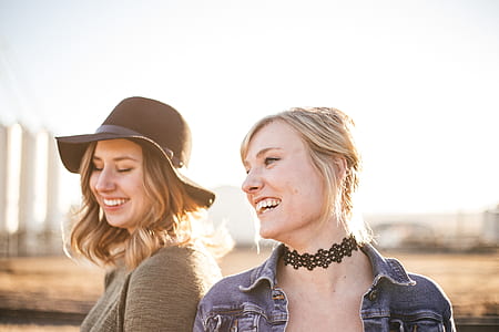 woman in blue denim jacket standing beside woman in gray shirt thumbnail
