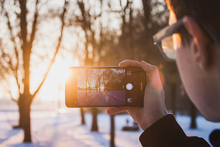person taking photo of sunset thumbnail