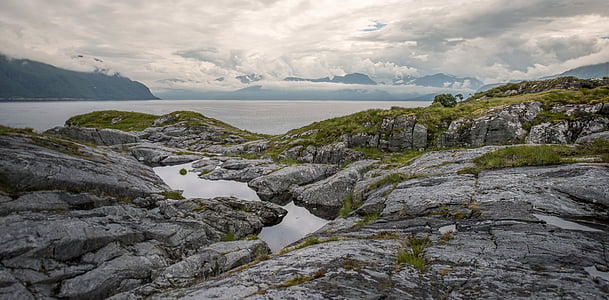 rocky platform near body of water thumbnail