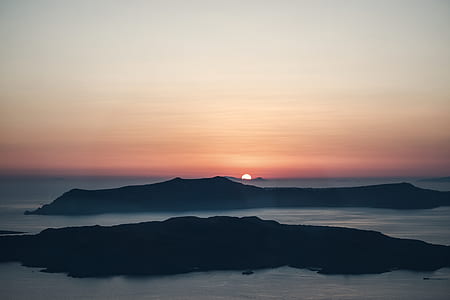 landscape photography of body of water near mountain during night time thumbnail