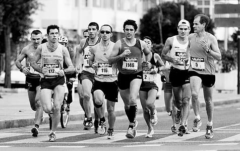 grayscale photo of people running on stret thumbnail