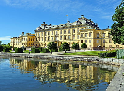 yellow and green building near lake thumbnail