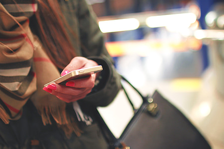 woman wearing black coat holding phone thumbnail
